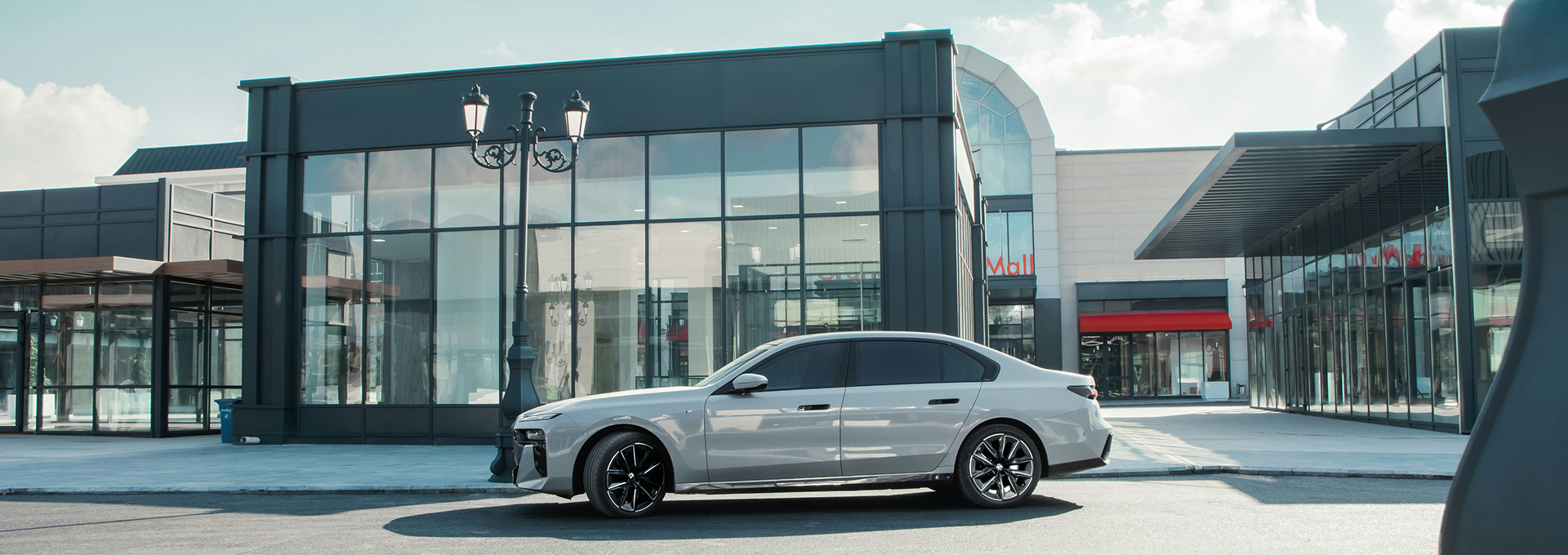 Car parked in front of a grey building